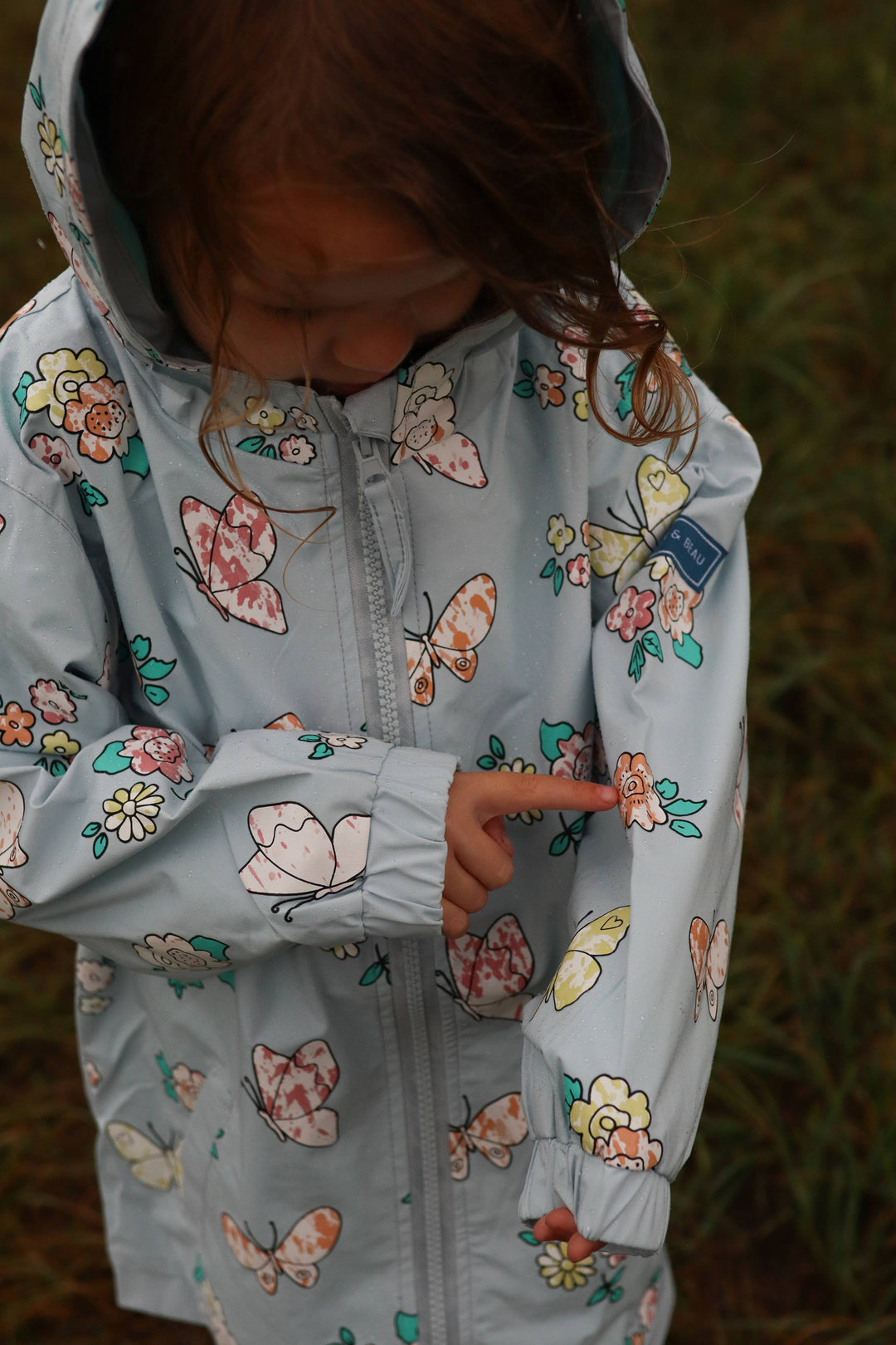 Holly & Beau Flower and Butterfly Color Changing Raincoat model close