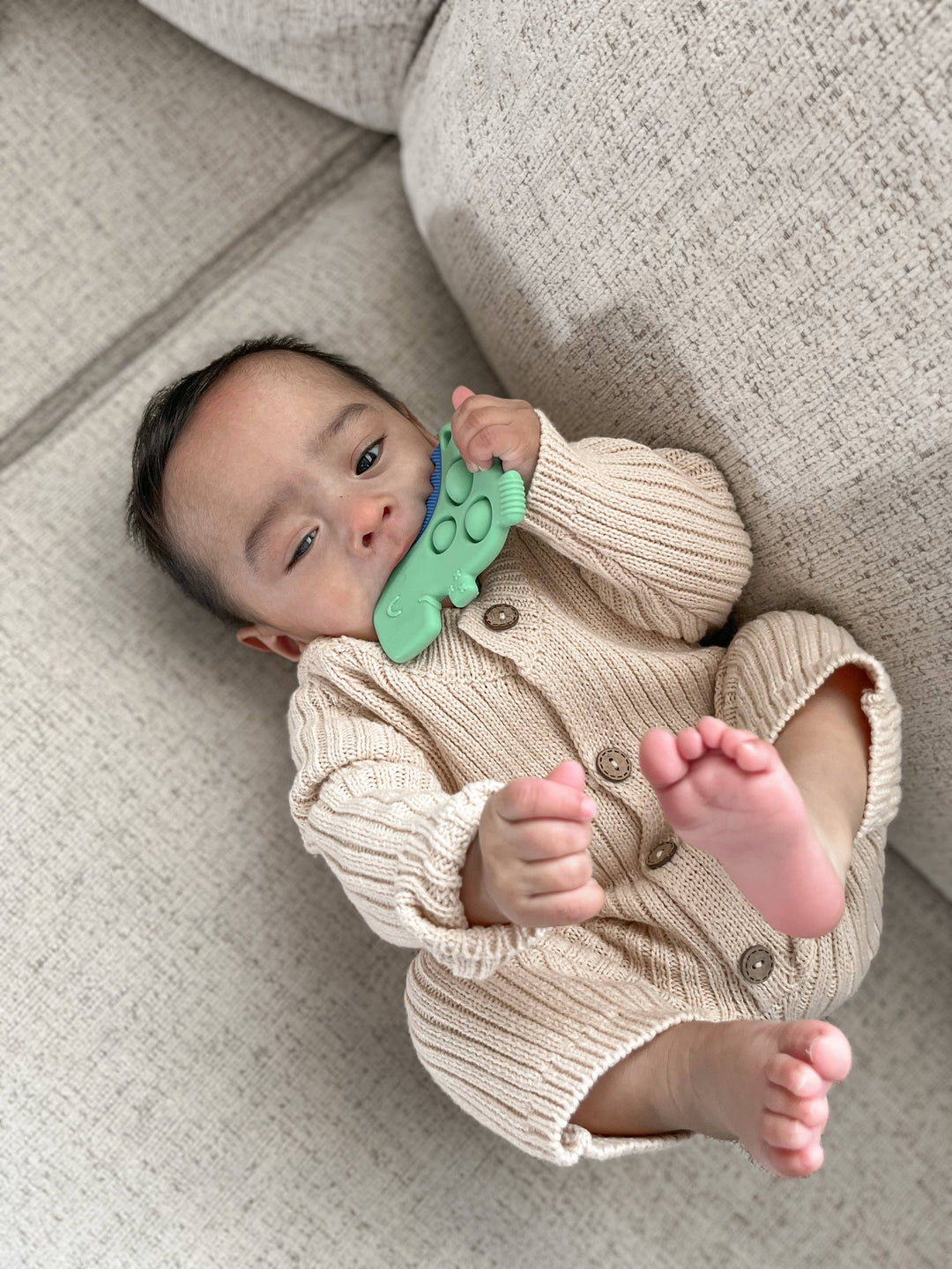 Itzy Ritzy Dino Itzy Pop™ Sensory Popper Toy model laying