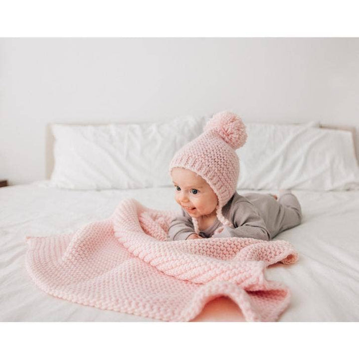 Huggalugs Blush Garter Stitch Knit Blanket Baby model bed