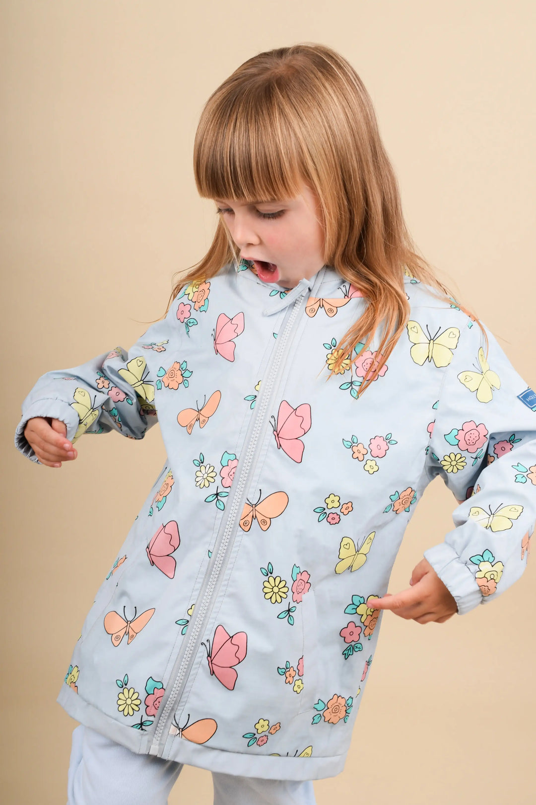 Holly & Beau Flower and Butterfly Color Changing Raincoat model indoors