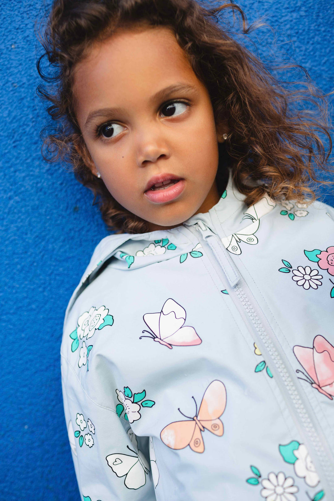 Holly & Beau Flower and Butterfly Color Changing Raincoat model wall