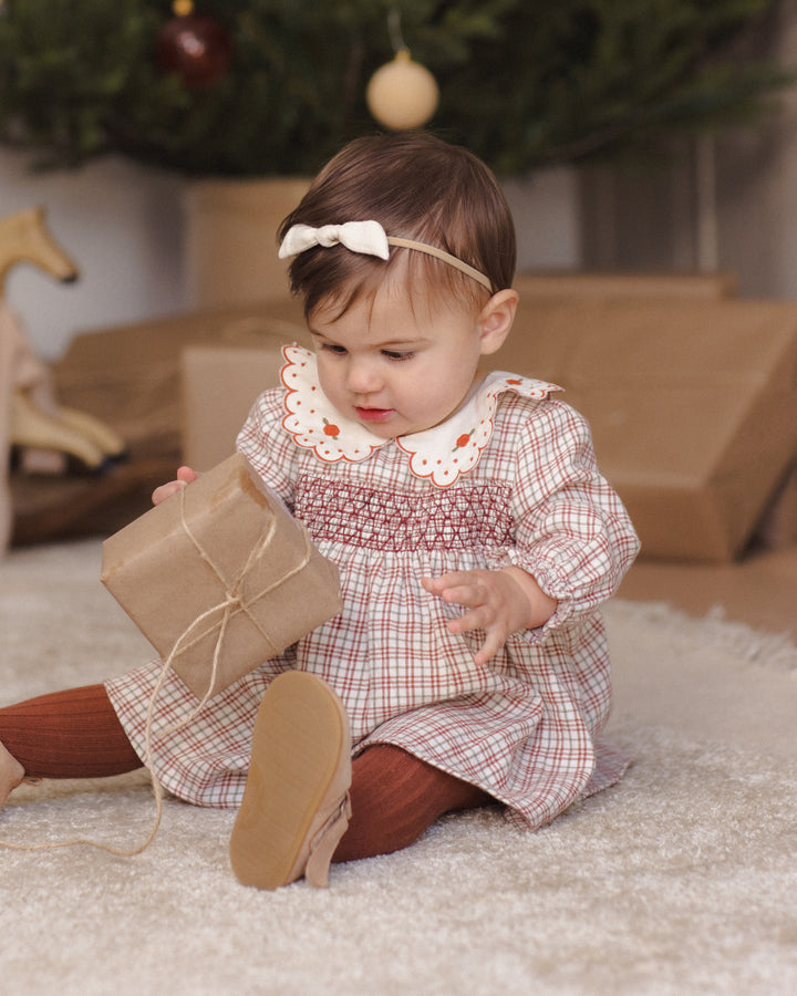 Quincy Mae Callie Christmas Plaid Dress model seating