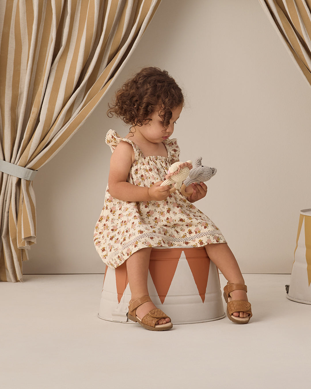 Quincy Mae Natural Bloom Ruffle Dress model seating