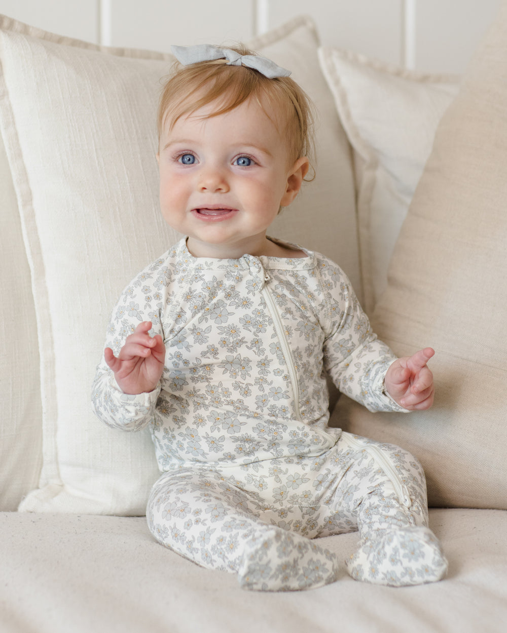 Quincy Mae Blue Floral Bamboo Footie model seating