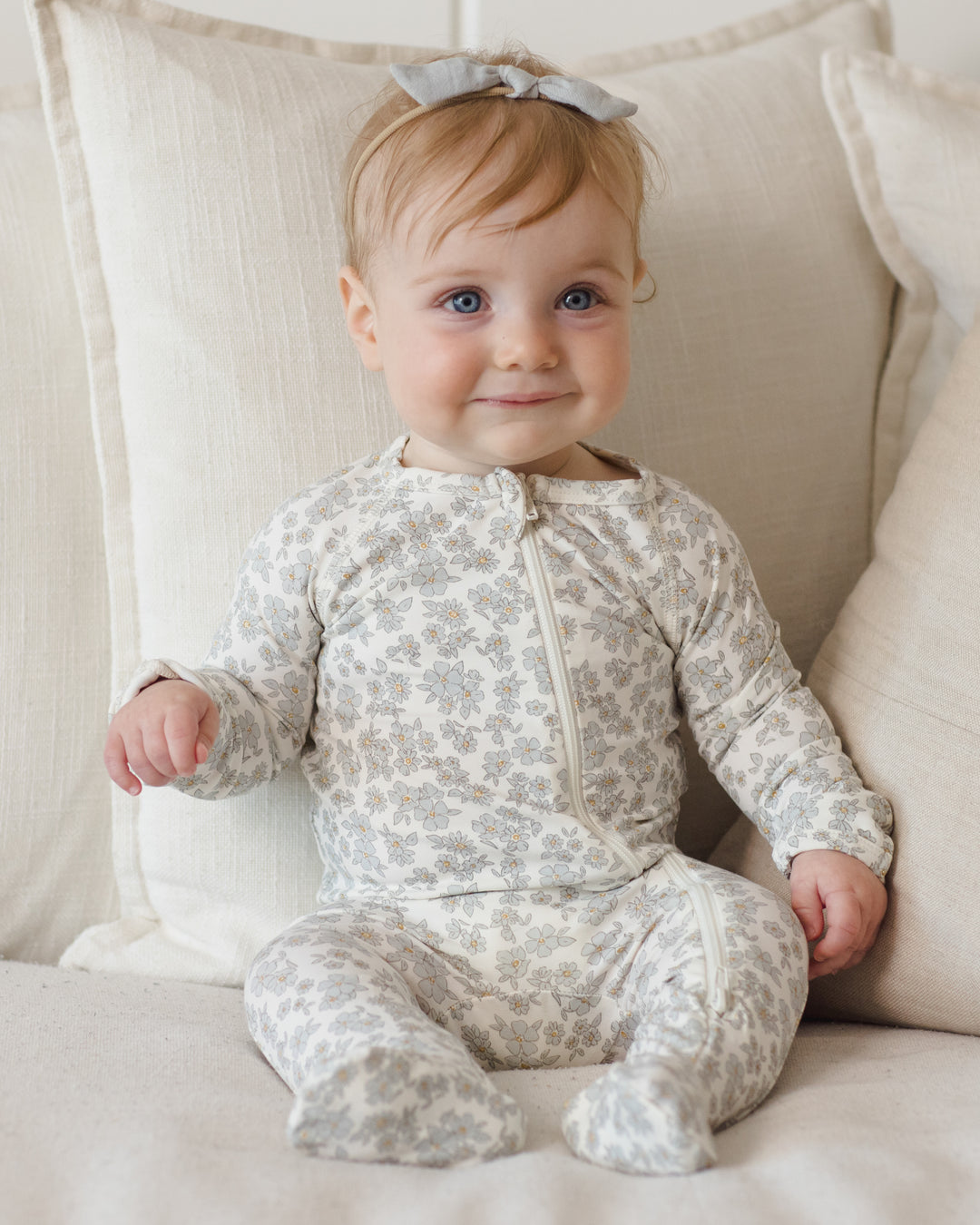 Quincy Mae Blue Floral Bamboo Footie model smile