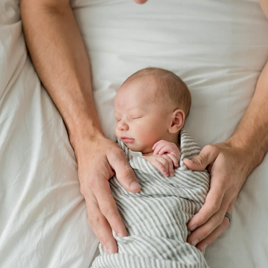 Little Unicorn Gray Stripes Swaddle hands