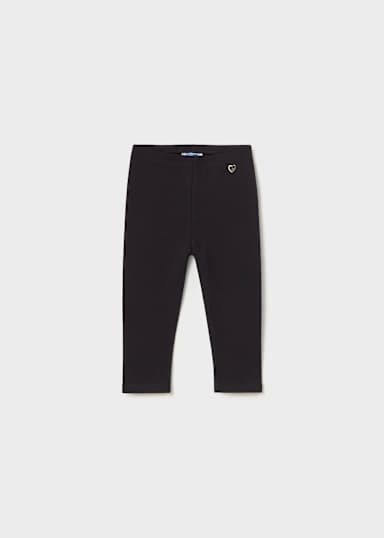 Black cropped leggings with a small white embroidered heart logo on the left hip, displayed flat against a light gray background.