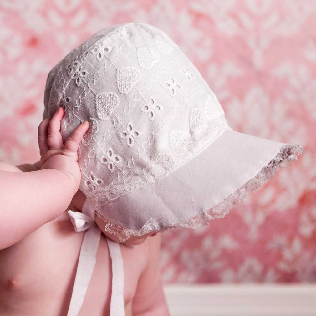 Huggalugs Heart Eyelet Baby Bonnet model side