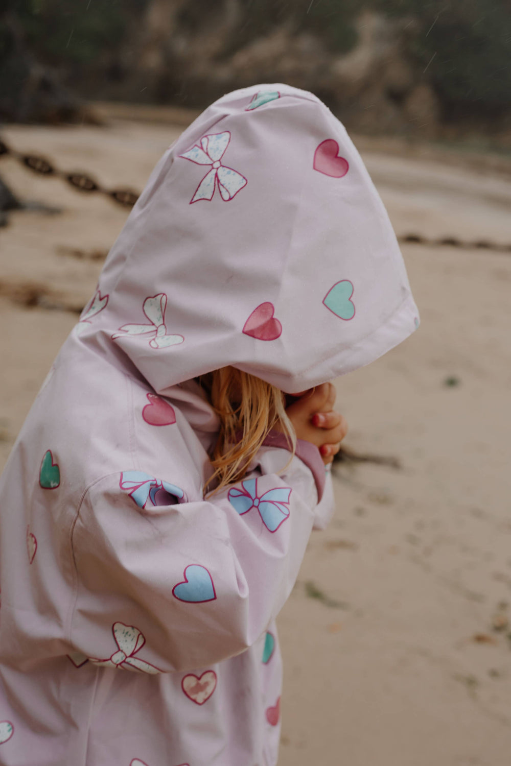 Holly & Beau Hearts & Bows Color Changing Raincoat model hood