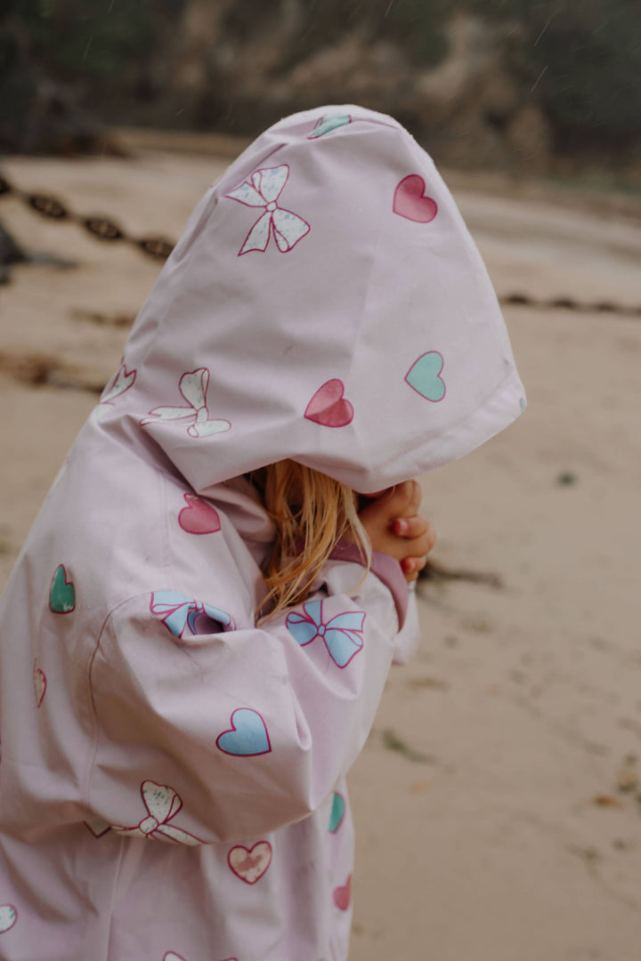 Holly & Beau Hearts & Bows Color Changing Raincoat model hood